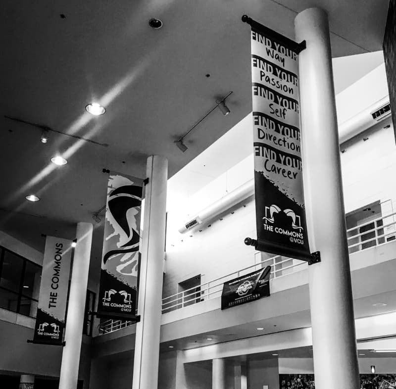 Interior of The Commons building with long vertical banners on columns